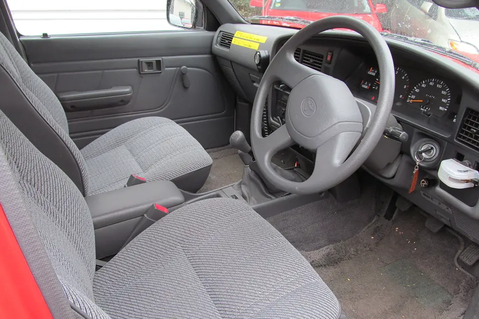 Clean pickup cab with cloth seats and dashboard