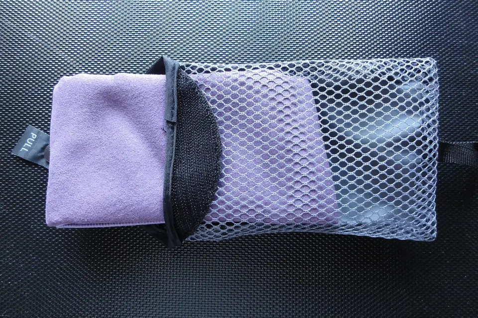 Folded microfiber towel in a mesh pouch