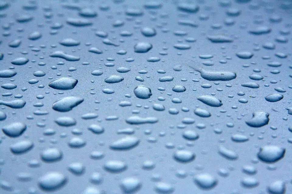 Water beading on blue car paint
